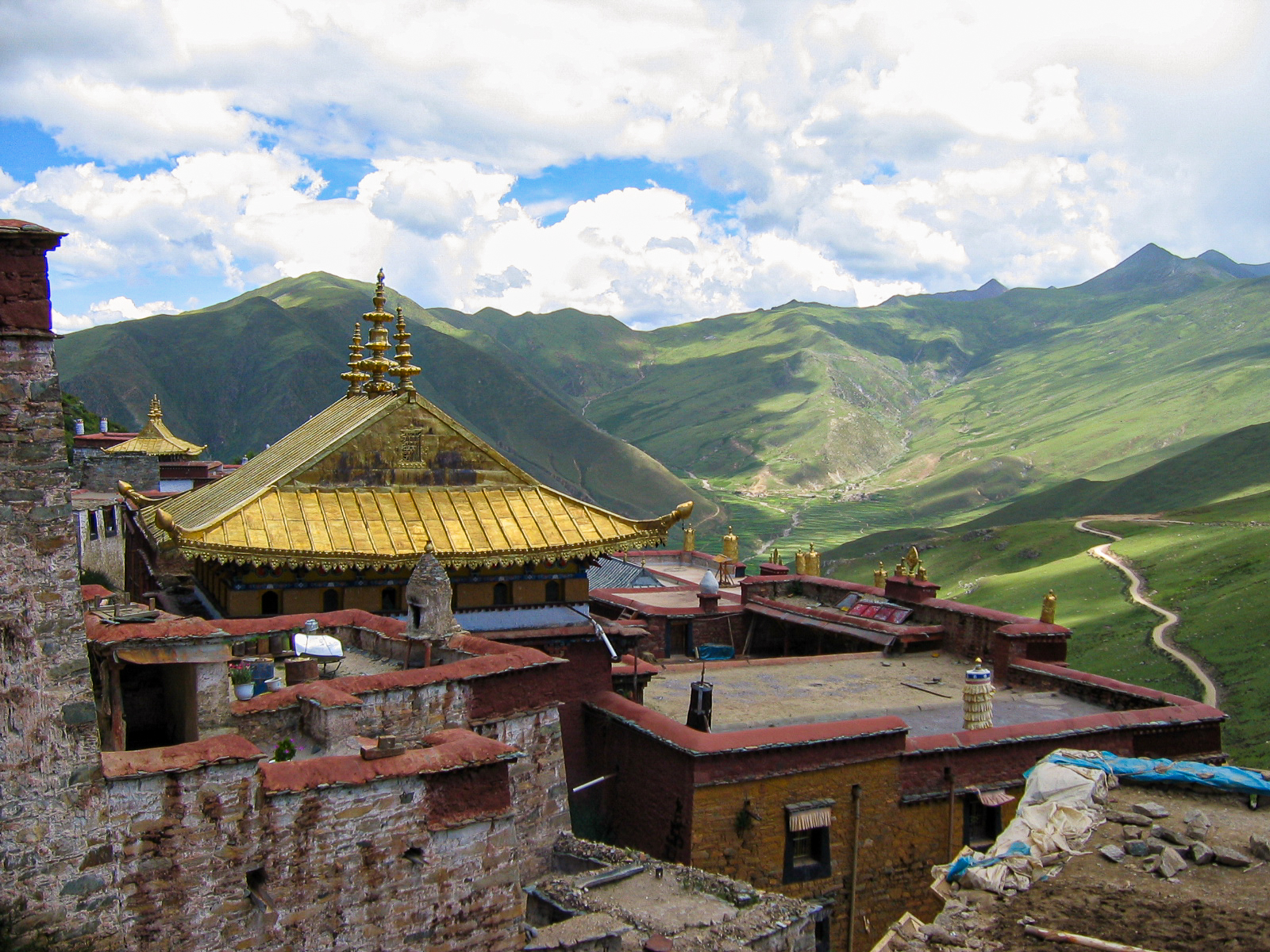 Ganden Monastery - Lhasa - The golden roofs of the assembly hall and the views over the valley below