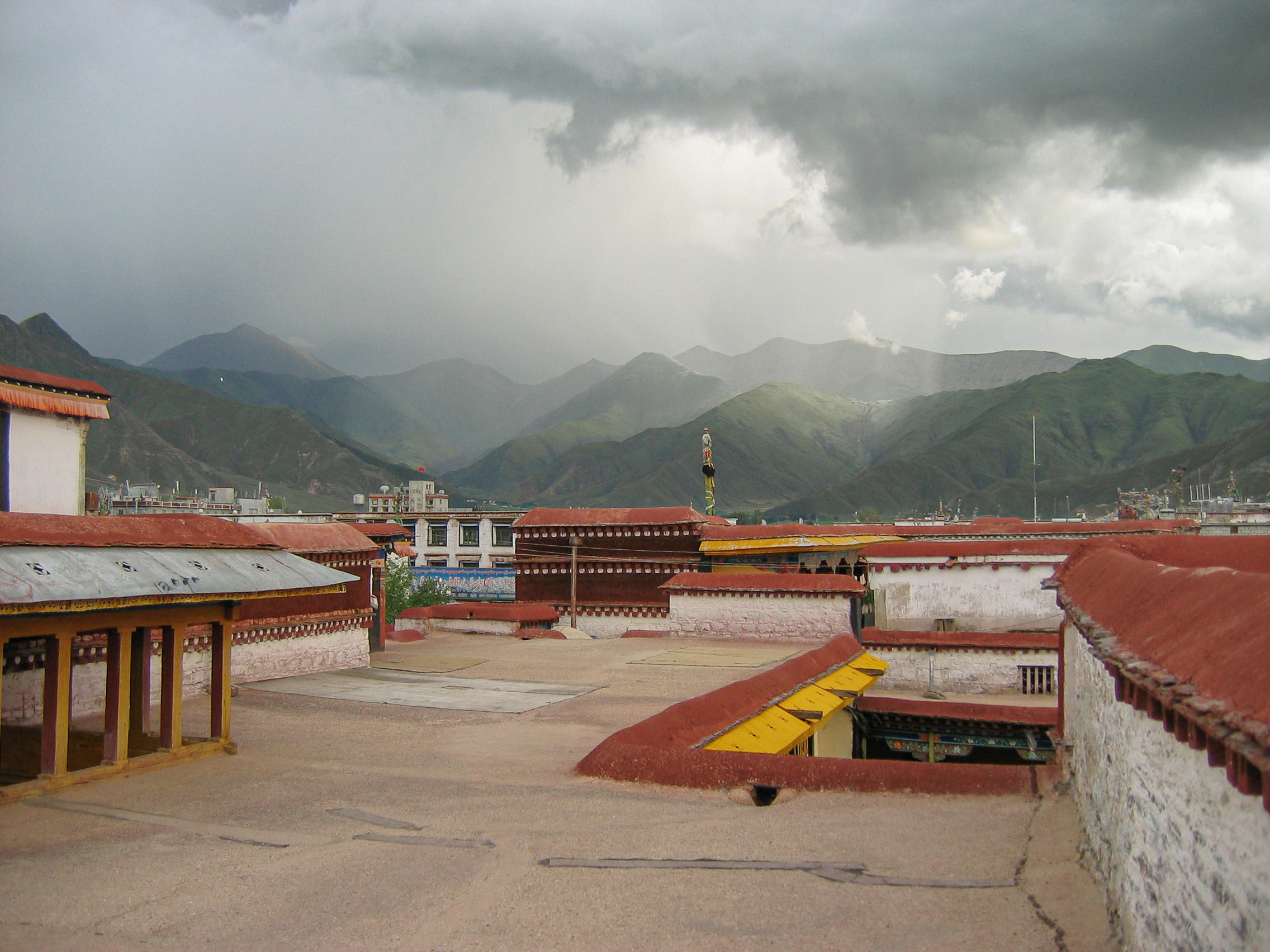 Watching a distant storm from the roof of the Jokhang Temple. Lhasa. Tibet.