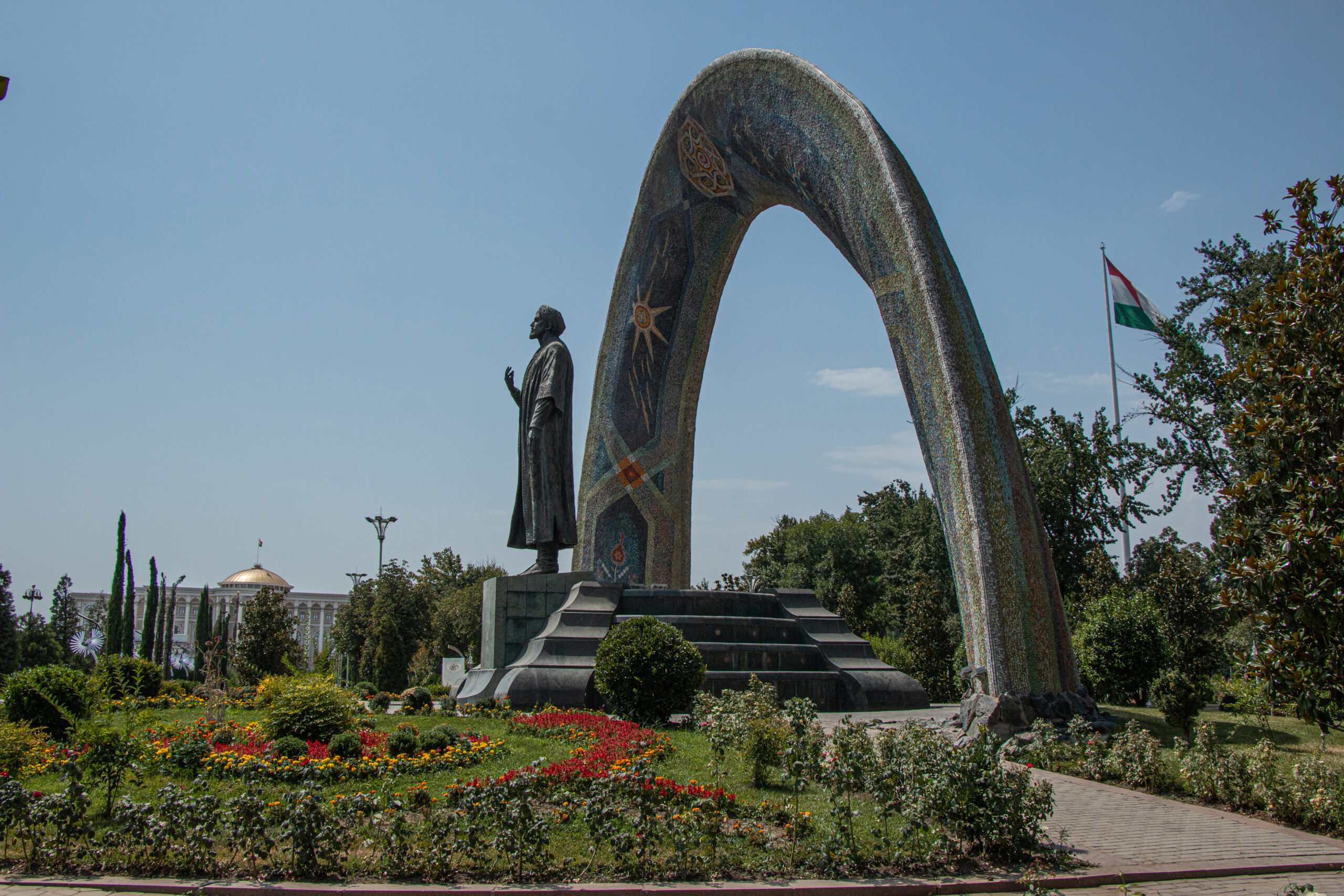 Dushanbe - Statue of the classic poet Rudaki with the Tajikistan National Library in the background.