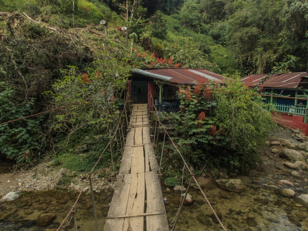 Suspension bridge through a hamlet at the beginning of the trail to The Lost City