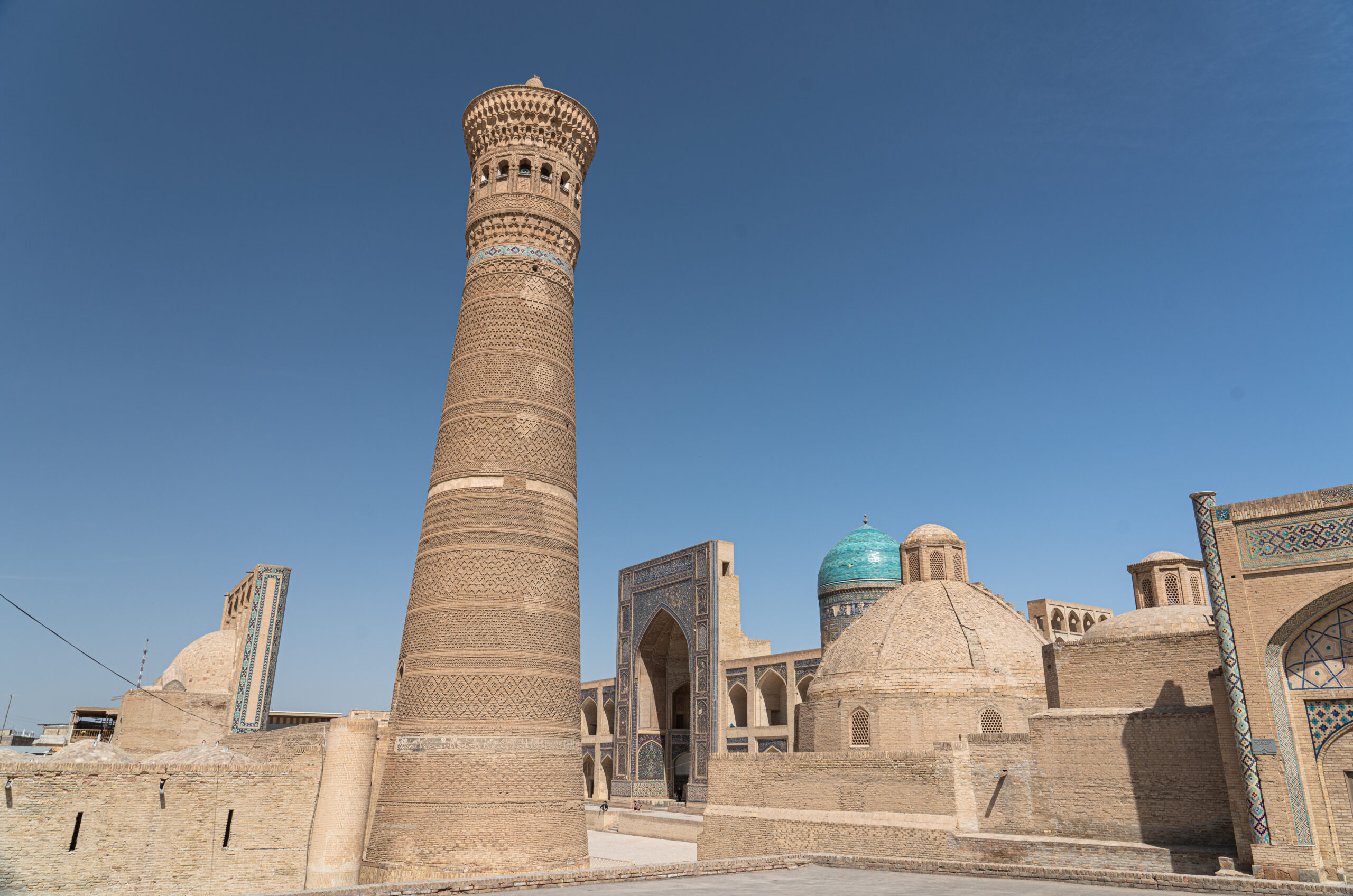 Uzbekistan - Bukhara - The Kalon Minaret and the entrance to Mir-i-Arab Madrasah