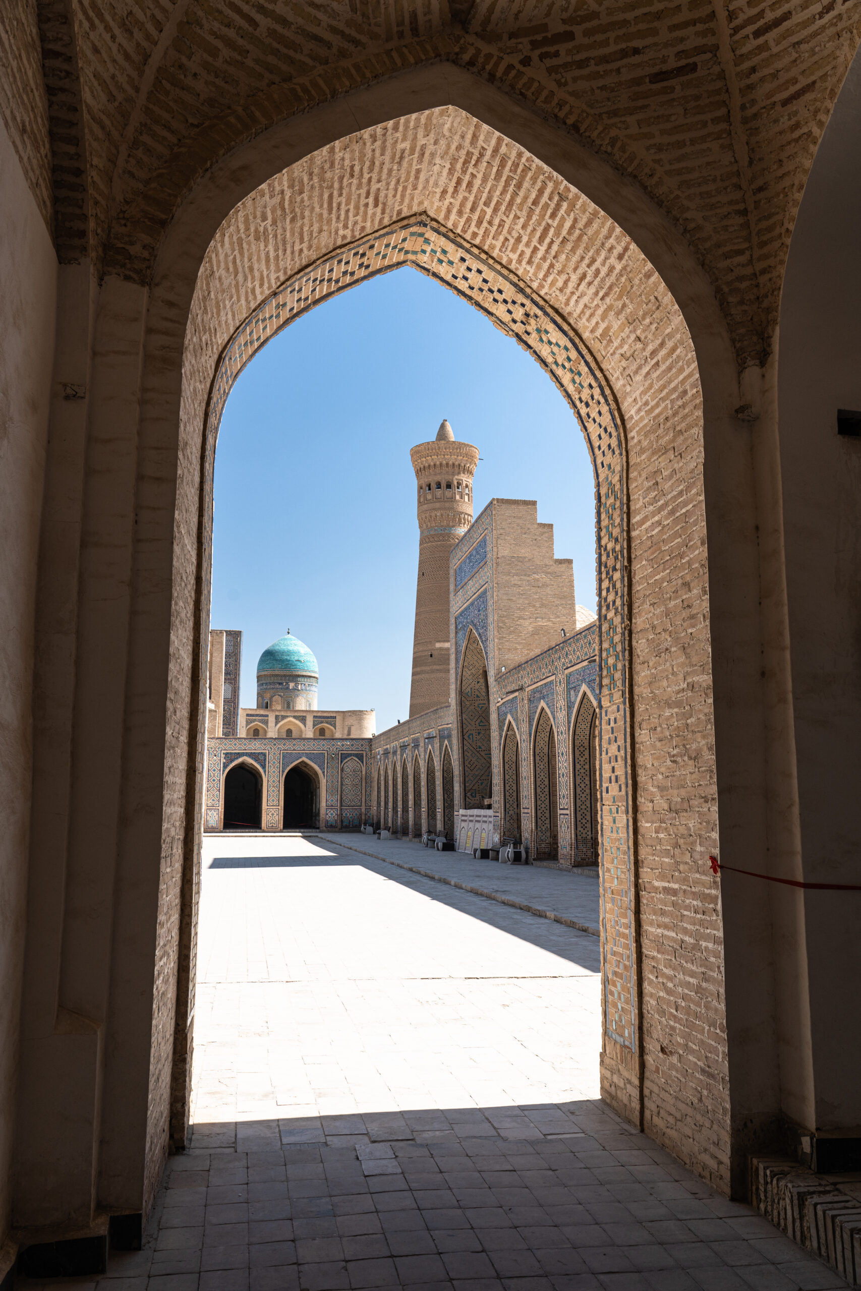 Uzbeksiatan - Bukhara - Looking across the courtyard of the Kalon Mosque towards the Kalon Minaret