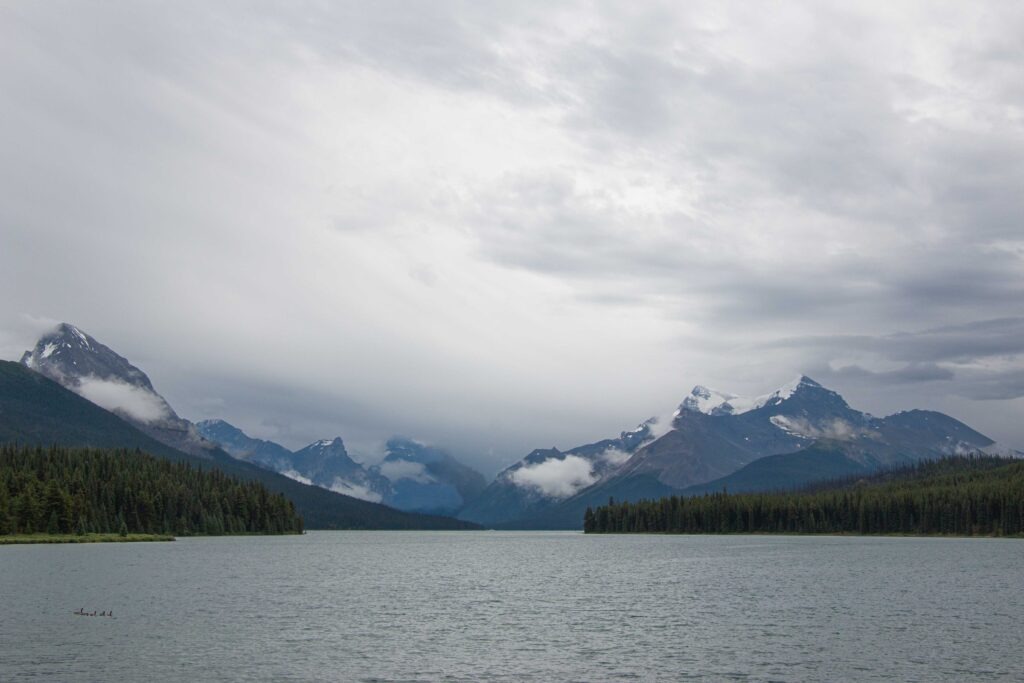 The clouds coming over the mountains alongside Maligne Lake